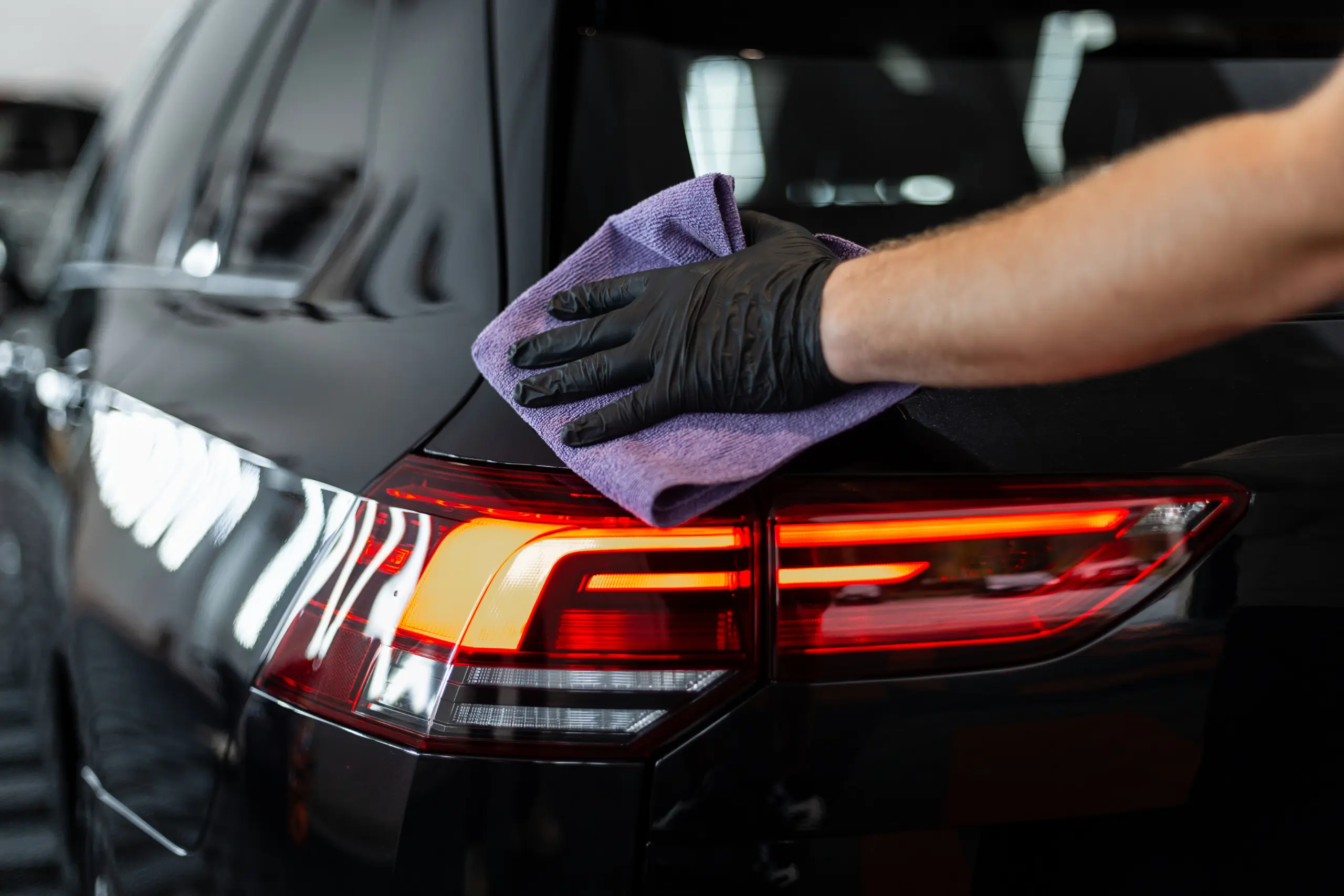 professional-man-washes-car-and-wipes-with-microfiber