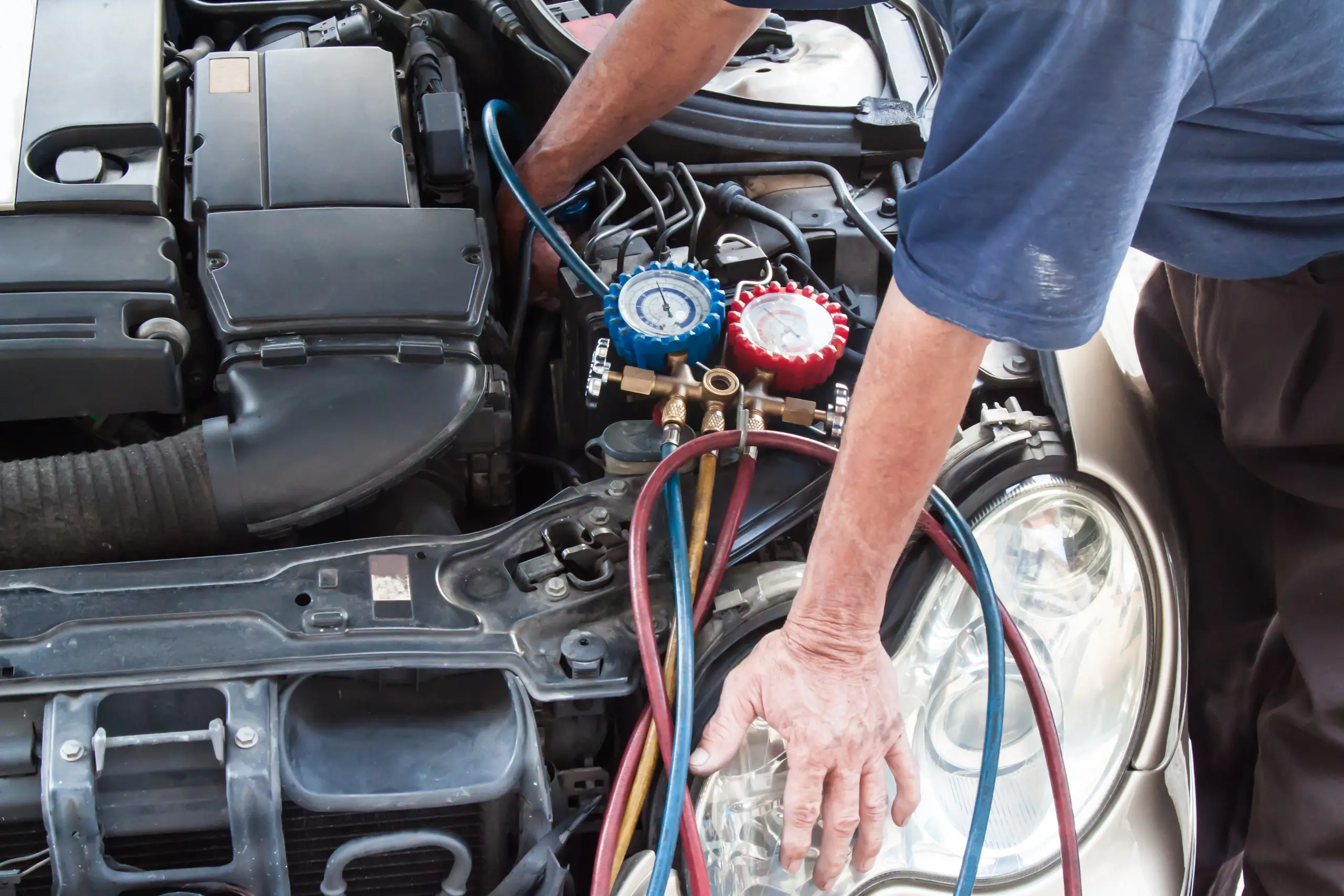 mechanic-with-manometer-inspecting-auto-vehicle