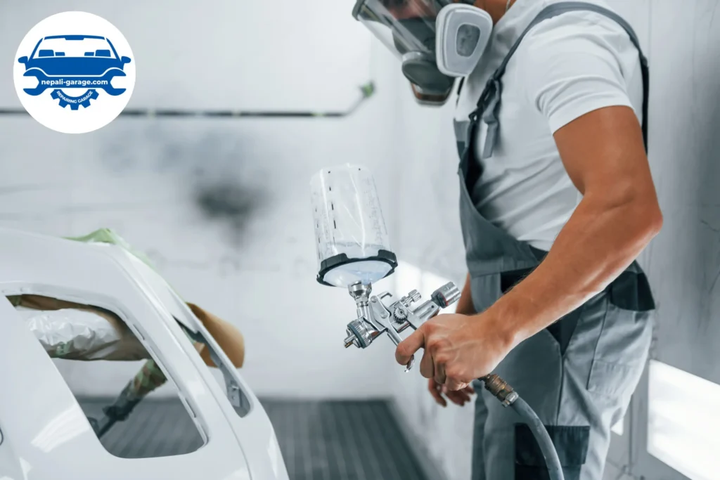 Mechanic is painting car in garage